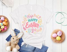 a t - shirt with the words happy easter on it next to a stuffed bunny