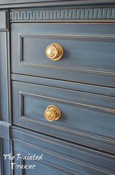 a blue dresser with gold handles and knobs on it's drawers, the painted drawer