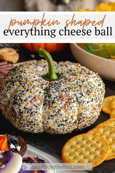 a pumpkin shaped everything cheese ball with crackers