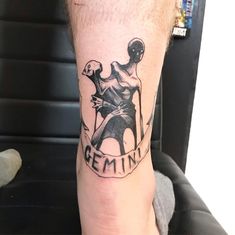 a man's leg with a tattoo on it that says reminin and an image of a woman holding a knife