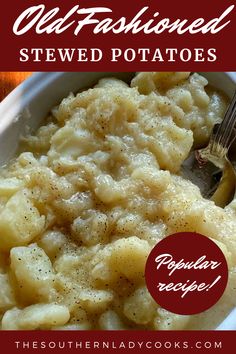 a white bowl filled with potatoes covered in gravy and topped with a fork