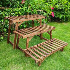 two wooden benches sitting in the grass