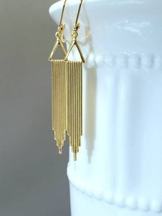 Textured Front, Hollow Back It doesn't get any simpler than these classic everyday Art Deco style earrings. The design is sleek, modern, and timeless. The earrings feature textured stylized waterfall gold plated stamped brass pendants. PLEASE NOTE: These earrings are hollow on the reverse side. (SEE 2nd PHOTO) Simple yet stunning; and light as a feather (lobe friendly) yet sturdy. Perfect everyday, every occasion earrings that you will reach for again and again. The earrings measure about 2 1/4 Vintage Gold Long Drop Earrings, Art Deco Gold Dangle Earrings, Handmade Art Deco Gold Earrings, Art Deco Drop Earrings With Ear Wire, Handmade Art Deco Dangle Earrings, Art Deco Dangle Brass Earrings, Art Deco Dangle Earrings, Stylized Waterfall, Flapper Jewelry