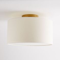 a white lamp hanging from the ceiling in a room