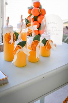 there are oranges in jars on the table