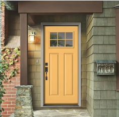 a yellow front door on a brick house