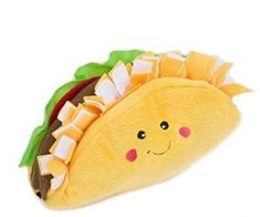 a stuffed toy taco with lettuce and cheese on it