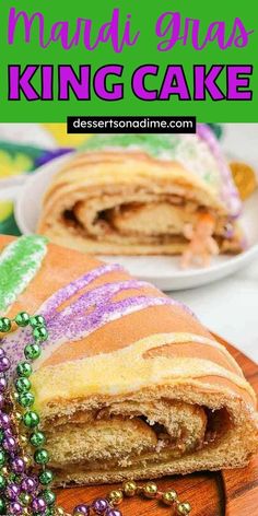 a mardi gras king cake is cut in half and stacked on a plate