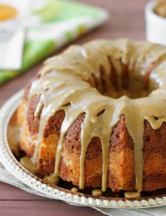 a bundt cake with icing sitting on a plate