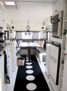 the interior of a camper with black and white decor