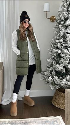 My fav is this long hunter green puffer vest! Paired with mt white long-sleeve tunic and leggings. Witner outfit, elevated casual outfit, outfit inspo, neutral style. #winteroutfit #winterstyle #puffervest #longpuffervest #winterstyle #casualwinteroutfit #elevatedoutfit Long Vest Puffer Outfit Ideas, Leggings Puffer Vest Outfit, Outfits With Long Puffer Vests, Sweatsuit With Puffer Vest, Puffer Vest Outfits For Women Winter, Green Puffer Vest Outfits For Women, Olive Puffer Vest Outfit, Long Vest Outfits For Women Casual, Green Vest Outfit Fall