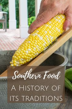 corn on the cob being grated with a wooden spatula and text southern food a history of its traditions