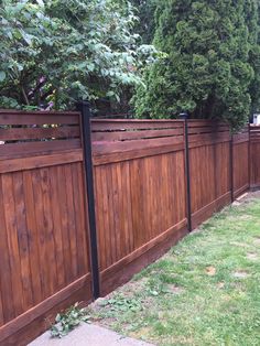 a wooden fence in the middle of a yard