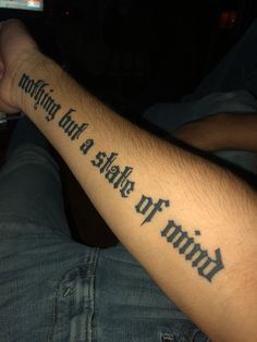 a man with a tattoo on his arm that says, nothing is safe to mind