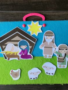 a nativity scene with cut outs and magnets to match the colors of the nativity