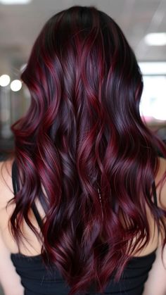 Wavy hair with deep burgundy highlights cascading down the back. Burgundy Makeup Looks, Cherry Red Highlights, Burgundy Makeup Look, Burgundy Makeup, Red Balayage Hair, Red Balayage, Red Tone, Red Highlights, Rich Burgundy