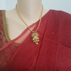 "Handmade Indian Jewelry item * Stunning Hand made Traditional jewelry set. * Necklace Set is a combo of Necklace & Stud Earrings * Necklace is adjustable with adjustable back chain/ Dori/ Cord * Main Necklace Length: 18\", Pendant length H : 2\" and W 1.25\" * Earring Length: 1\", Earring Width: 0.6\" * Packed in a box, Ideal For GiftingOn Request, We Can Add A Custom Message For Your Loved One (At No Additional Cost) :) * Gold Color is Matte gold tone, which has a copper hue as opposed to Traditional Gold Kundan Necklace With Beaded Chain, Temple Jewelry Style Metal Necklace As Gift, Beaded Pendant Jewelry For Festivals, Festive Pendant Jewelry With Beaded Chain, Spiritual Gold Jewelry Sets For Festivals, Metal Temple Necklace As Gift, Spiritual Jewelry With Beaded Chain For Festivals, Spiritual Beaded Chain Jewelry For Festivals, Temple Style Metal Pendant Necklace