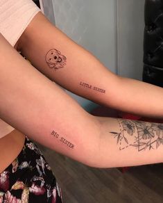 two people with matching tattoos on their arms