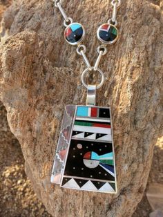 This is an exceptional Necklace handmade by renowned Zuni artist Harold Smith.Signed and Stamped " Sterling"Measurements:22 1/2" Chain ( length not including pendant)Pendant is 2 3/16" ( includes 1/2" removable bale) L x 1 7/16" W51.4 Grams Pre-owned in excellent vintage condition. Some Patina But no damage.Ships USPS Priority Insured Mail Unique Round Pendant Inlay Necklaces, Artisan Necklace With Inlay In Sterling Silver, Artisan Sterling Silver Necklace With Inlay, Artistic Polished Pendant Necklaces, Artistic Polished Pendant Necklace, Unique Multicolor Inlay Necklaces, Unique Multicolor Inlay Necklace, Artistic Pendant Necklace With Polished Finish, Artisan Necklace With Round Pendant Inlay