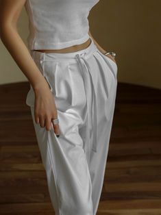 Chic, classic trendy trousers with two pin tucks. Tie in waistband. Lounging comfortable style. Model is in MINUSEY ONE SIZE. ✔️ Free worldwide express shipping over $100✔️ Loved by 6,500+ customers✔️ Limited edition collections, maximum style⠀⠀⠀⠀⠀⠀⠀⠀⠀Stay ahead of the trend with can’t-find-anywhere-else staples. Your closet will thank you 💕 * MINUSEY ONE SIZE = EU 34-38, US 2-6* 65% Cotton / 30% Nylon / 5% Spandex* Dry clean* Made in Korea - Model Height: 172cm/5'7" (US2, EU34) Casual White Bottoms With Pleated Waist, Casual White Pleated Waist Bottoms, Elegant Cotton Bottoms With Pleated Waist, White Wide-leg Bottoms With Pleated Waist, White Wide Leg Bottoms With Pleated Waist, White Pleated Waist Bottoms For Work, Trendy Trousers, Lounge Trousers, Trendy Trouser