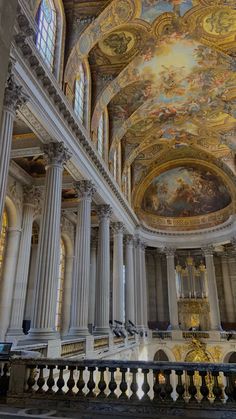 the interior of a large building with painted ceilings