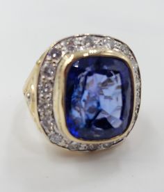 Title: Designer: Unbranded Material:Yellow Gold 14KT Style: Fashion Vintage Gemstone Details All measurements are approximate and may vary slightly from the listed dimensions. Diamonds Stones 18 Round Diamonds 2.3 mm 0.90 CTW Violet- Blue Cushion cut Tanzanite Stone is Cracked through the table 14.3mm/12.3mm/7.5mm 10.67 Cts Estimated Measurements Length/Width/Depth Size 7 US 23.48mm/14.36mm Estimated Total Weight Dwt: 8.6 Grams: 13.3 ConditionUsed Condition- Tanzanite is cracked -Gold is polishe Cushion Cut Tanzanite Jewelry In White Gold, Gia Certified Cushion Cut Tanzanite Ring, Cushion Cut Tanzanite Jewelry For Gifts, Cushion Cut Tanzanite Jewelry Gift, Luxury Cushion Cut Tanzanite Jewelry, Tanzanite Diamond Ring, Amethyst Studs, Tanzanite Stone, Blue Cushions