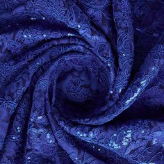 an image of blue fabric with sequins on it