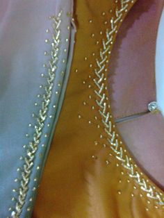 two different colored dresses with gold and silver beads on the bottom, one in yellow