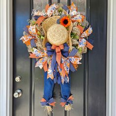 an orange and blue scarecrow hat hangs on the front door