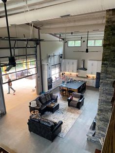 a living room filled with furniture next to a kitchen and an open concept floor plan