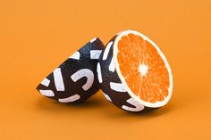 two orange halves cut in half on an orange background