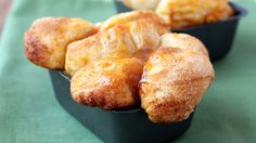 three small trays filled with pastries sitting on top of a green table cloth