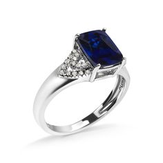 Introducing a mesmerizing masterpiece crafted to captivate hearts! Behold this .925 Sterling Silver Engagement Ring, adorned with a dazzling 9X7 mm Cushion Cut Blue Sapphire, flawlessly complemented by 28 natural White Diamonds. The enchanting blue hue of the lab-created Sapphire, enhanced with color treatment, exudes elegance and sophistication. With a total gemstone weight of 2 carats, this ring showcases the perfect balance of luxury and grace. The shared prong setting ensures maximum brillia Sapphire And Diamond Engagement Ring, Silver Cushions, White Diamond Ring, Sterling Silver Engagement Rings, Silver Engagement Rings, Silver Diamonds, Cushion Cut, White Diamond, 925 Sterling Silver Ring