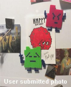 a refrigerator with magnets and pictures on the fridge door that says happy birthday to you