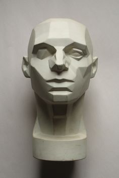 a white head statue sitting on top of a table