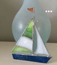 a glass sailboat sitting on top of a table