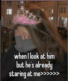 a girl with long hair wearing a tiara and holding her face to the side