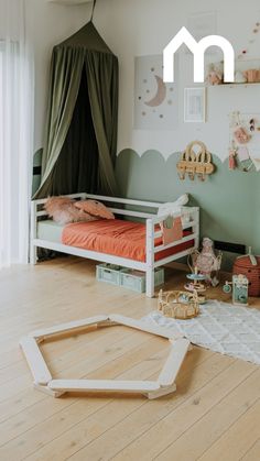 a child's bedroom decorated in pastel green and peach colors with a canopy bed