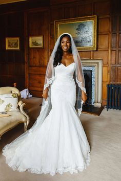 a woman in a wedding dress posing for the camera