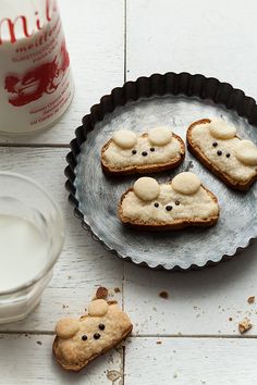 cookies shaped like mice on a plate next to a glass of milk