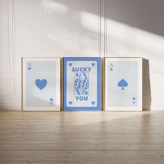 three playing cards with the words lucky, lucky and you on them sitting in front of a white wall