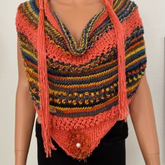 a mannequin wearing a colorful knitted shawl