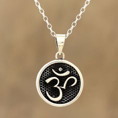 Within a darkly oxidized finish, the striking omkara symbol for the meditative mantra om gleams brightly from this sterling silver pendant necklace. Designer Shivani Choudhary works with Indian artisans to create this spiritual necklace. Oxidized Pendant For Meditation, Oxidized Finish Pendant For Meditation, Spiritual Oxidized Finish Jewelry For Meditation, Spiritual Sterling Silver Necklaces With Oxidized Finish, Spiritual Sterling Silver Necklace With Oxidized Finish, Spiritual Necklaces With Oxidized Finish For Meditation, Symbolic Oxidized Finish Necklace For Meditation, Symbolic Sterling Silver Necklaces For Festivals, Symbolic Oxidized Jewelry For Festivals