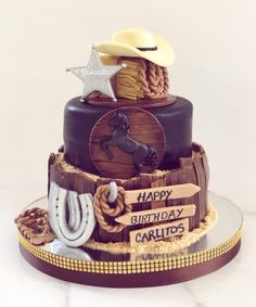 a birthday cake made to look like a cowboy's hat, boots and lasso