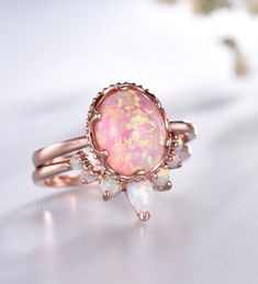 Opal Wedding Ring Set Oval Pink Fire Opal Engagement Ring Vintage Sterling Silver Ring Opal Matching Band Promise Ring Bridal Set Unique wedding set,perfect as engagement/wedding ring, birthday or anniversary gift, etc. Engagement Ring ❀gemstone is 8x10mm oval cut lab-created pink fire opal❀ ❀925 Sterling Silver,Rose/White/Yellow Gold Plated❀ Wedding Band ❀2.5mm+1.5mm Round cut and 3x5mm Pear cut lab-created white fire opal❀ ❀Curve height 4mm,curve width 9mm. ❀925 Sterling Silver,Rose/White/Yell Dark Opal Engagement Ring, Oval Prong Setting Bridal Sets As Gift, Oval White Gold Crystal Wedding Ring, Oval Bridal Sets With Prong Setting As Gift, Gold Bridal Sets With Round Gemstone, Gold Bridal Sets With Gemstones, Gold Opal Wedding Jewelry, Oval Halo Setting Wedding Jewelry, Heirloom Rose Gold Oval Opal Ring