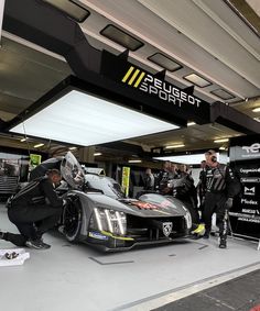 some men are working on a race car