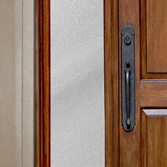 a close up of a door handle on a wooden door