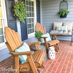 two wooden chairs sitting on top of a brick patio