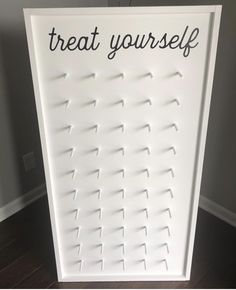 a sign that says treat yourself on the side of a door with pins stuck to it