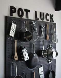 a peg board with pots and pans on it